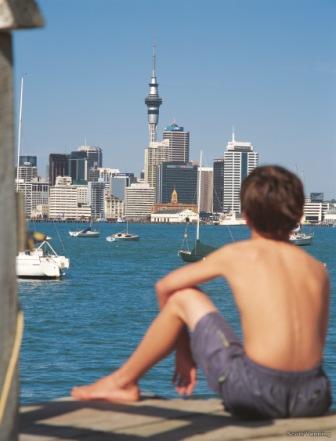 boy on dock looking at city